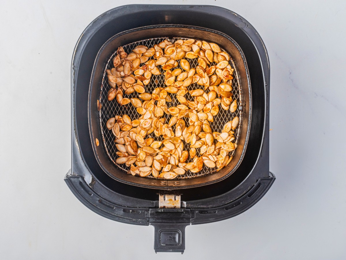 roasting pumpkin seeds in the air fryer basket.