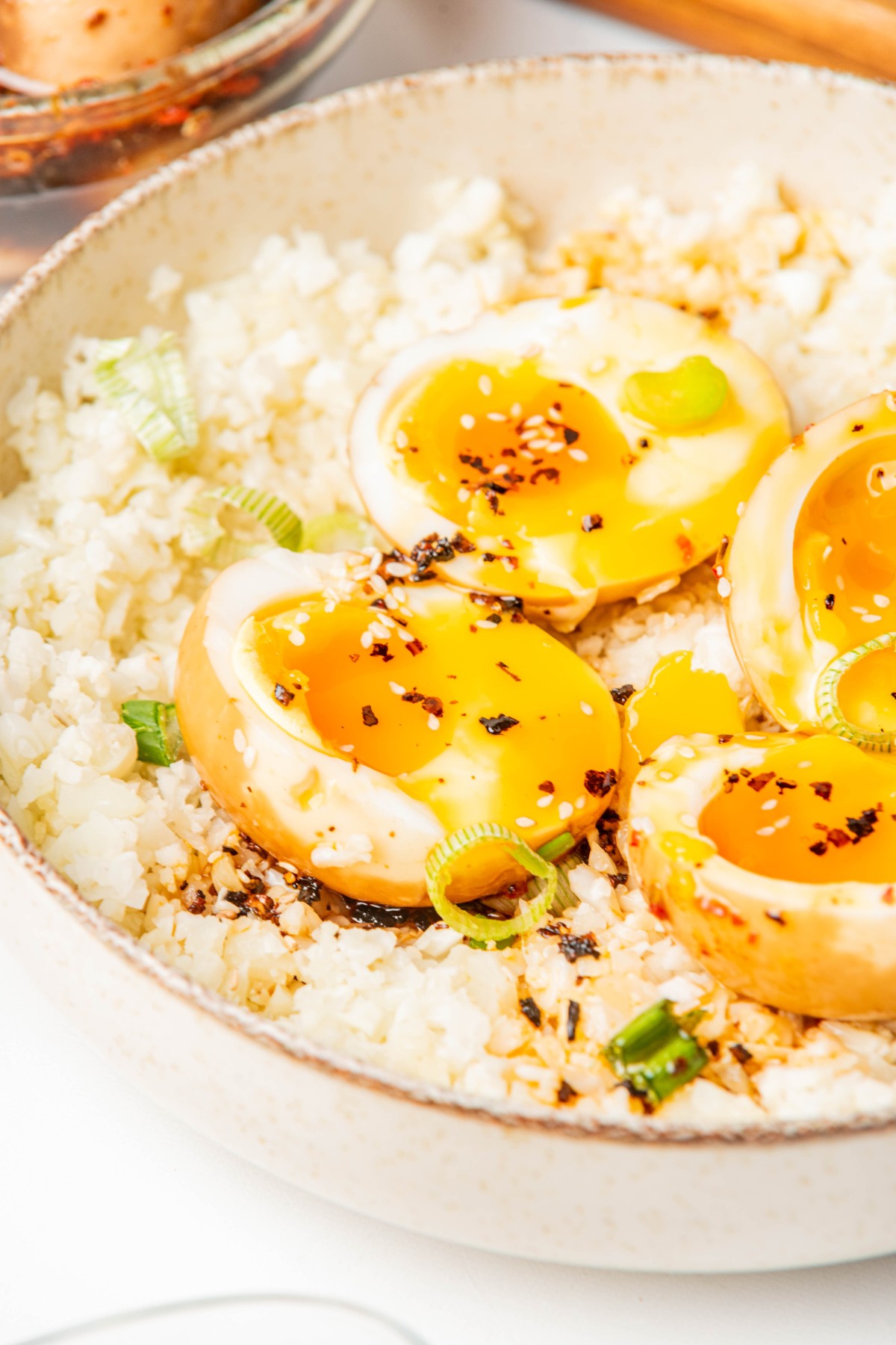 sliced korean eggs over cauliflower rice